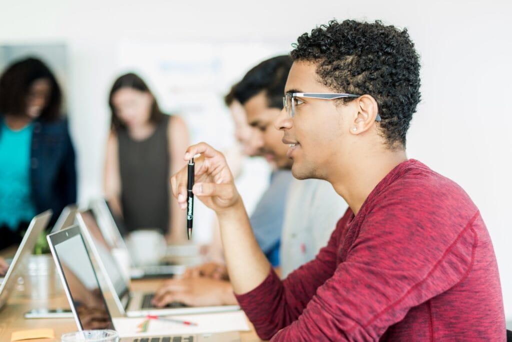 man-holding-pen-in-meeting