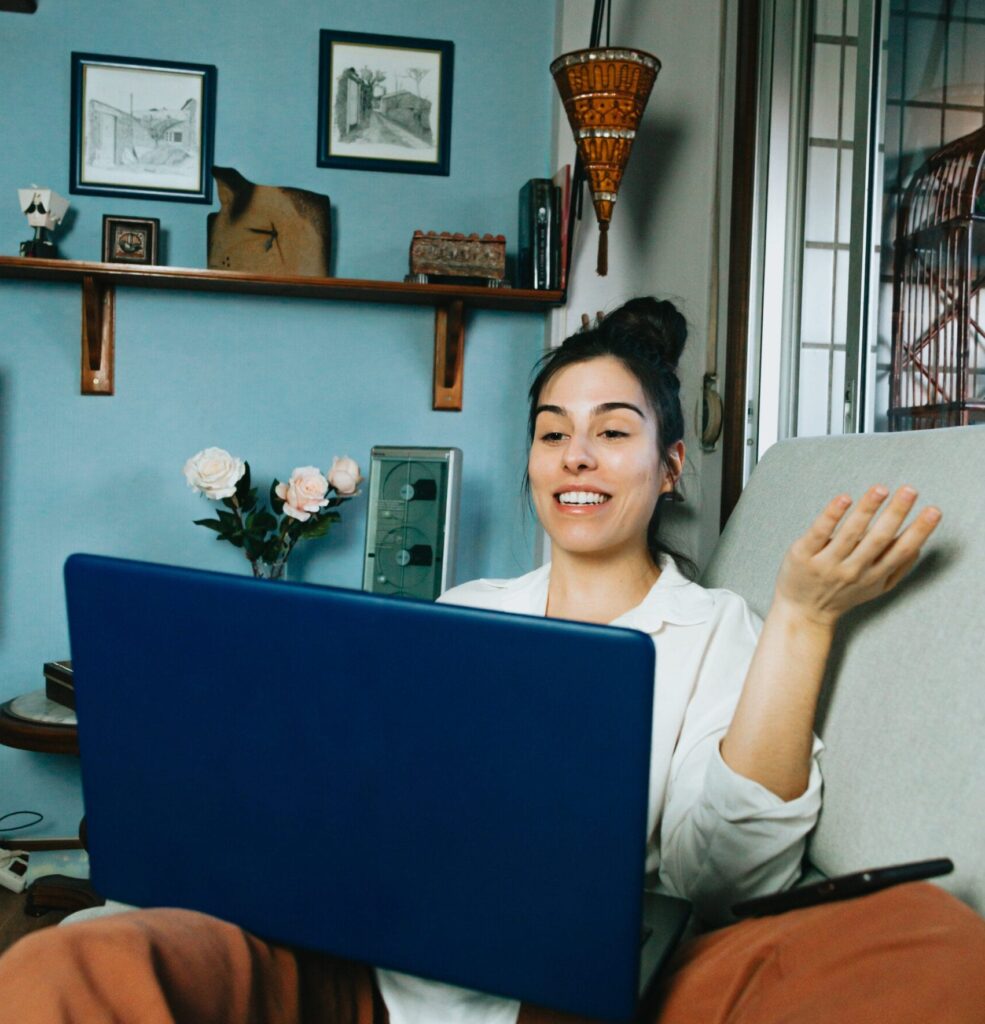 person-works-from-their-couch-talking-to-laptop-screen